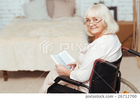 Pleasant disabled woman sittign in the wheelchair Pleasant disabled woman sittign in the wheelchair 26712700