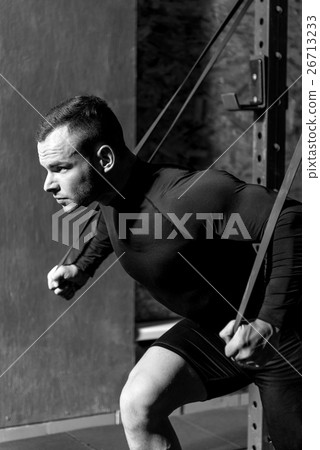 Confident muscular man doing a physical exercise 26713233