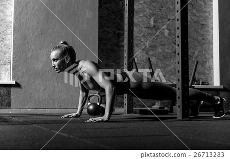 Beautiful well built woman concentrating on the 26713283