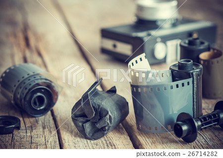 Old photo film rolls and cassette on desk. 26714282