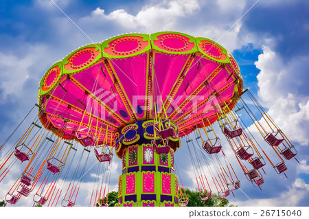 Colorful flying swing ride at the amusement park Colorful flying swing ride at the amusement park 26715040