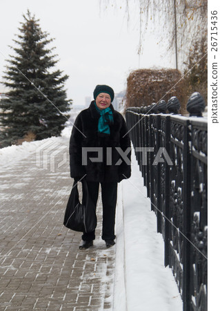 Portrait of senior woman at winter day standing in 26715436