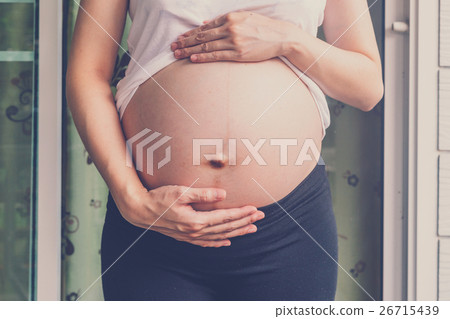 close up hand pregnant woman holding her tummy close up hand pregnant woman holding her tummy 26715439