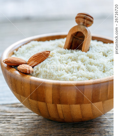Bowl with almond flour and a wooden scoop. 26716720