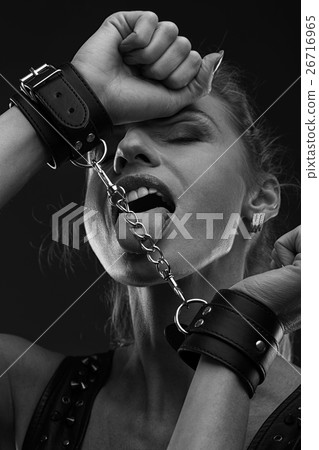Woman in leather handcuffs Woman in leather handcuffs 26716965