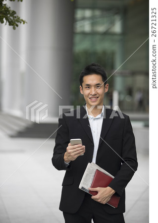Chinese business man using his mobile phone. Chinese business man using his mobile phone. 26721325