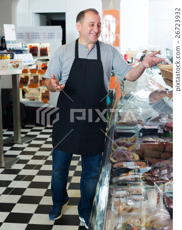 Salesman offering different sausages Salesman offering different sausages 26723932