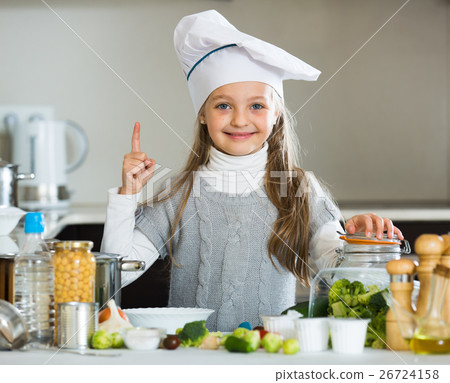 Sweet little girl in cook cap with sprouts and broccoli Sweet little girl in cook cap with sprouts and broccoli 26724158