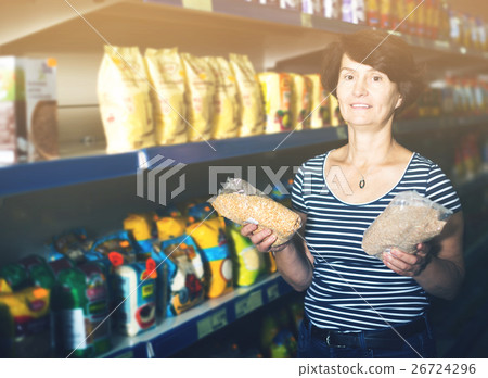 Elderly woman buying groats 26724296