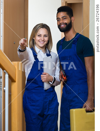handyman with assistant at entrance 26724396