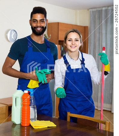 professional couple in uniform cleaning at domestic interior 26724502