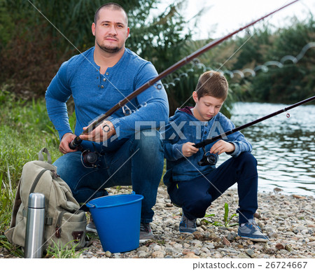 Man and little boy fishing 26724667