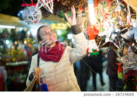 Woman at Christmas fair in evening 26724689