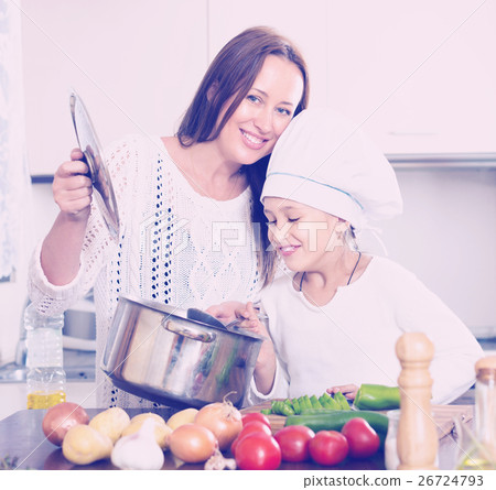 Smiling girl and mom at kitchen Smiling girl and mom at kitchen 26724793