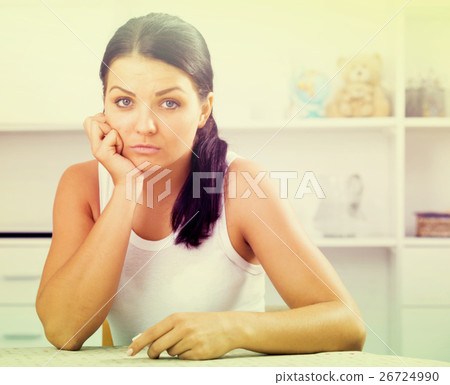 Young brunette woman wipes tears 26724990