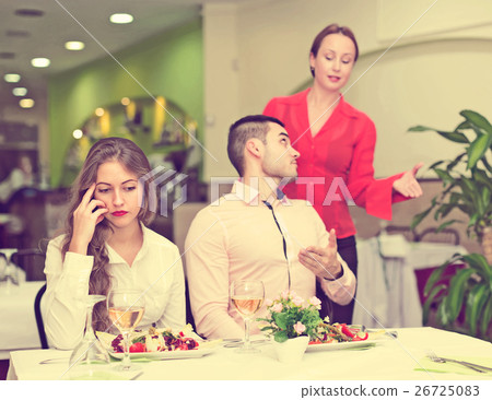 Unpleased couple in restaurant 26725083
