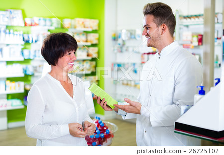 pharmacist helping customers pharmacist helping customers 26725102