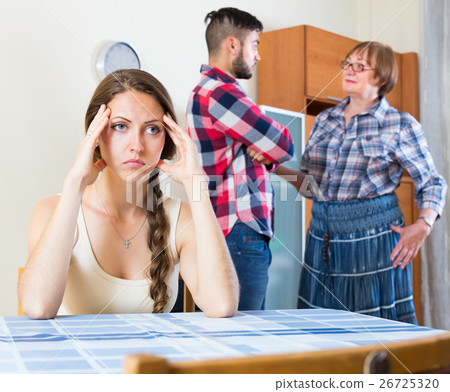 Sad girl listening family dispute and quarrel Sad girl listening family dispute and quarrel 26725320