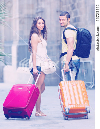 Travelers with baggage in the street 26725532