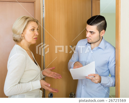 Serious man and housewife at the door 26725569