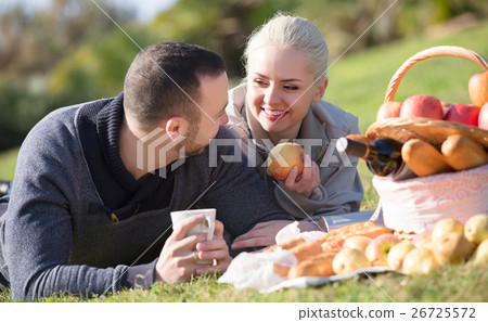 Spouses lounging at picnic outdoors Spouses lounging at picnic outdoors 26725572