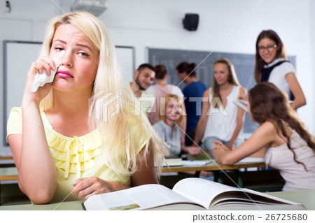Crying outcast student in college classroom Crying outcast student in college classroom 26725680
