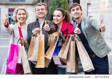 Close up of smiling tourists with purchases Close up of smiling tourists with purchases 26725691