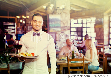 Adults having dinner and waiter 26725834