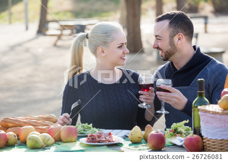 couple having picnic in sunny spring day at countryside 26726081
