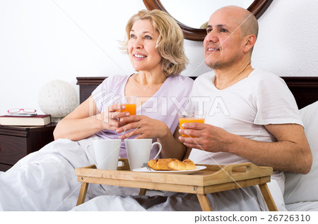 Couple having breakfast in bed 26726310