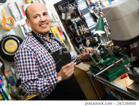 Senior professional with different types of keys in locksmith Senior professional with different types of keys in locksmith 26726600
