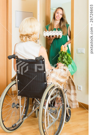 Social worker bringing food to invalid Social worker bringing food to invalid 26726603