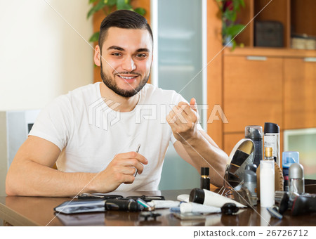 Man doing manicure at home 26726712