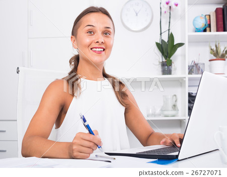 portrait of female business employee writing and working with laptop at office portrait of female business employee writing and working with laptop at office 26727071