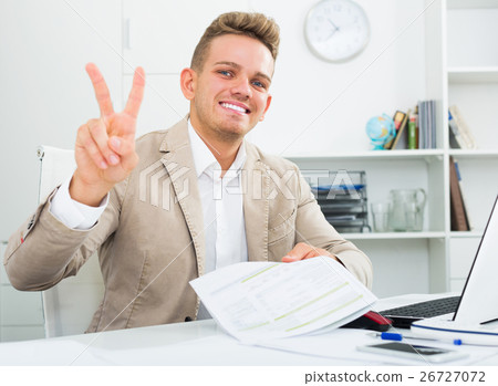 Businessman showing victory sign 26727072