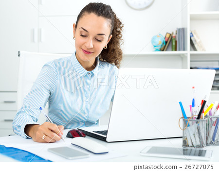 Business lady sitting at office desk with laptop Business lady sitting at office desk with laptop 26727075