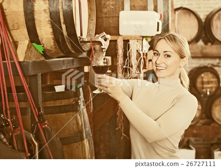 Portrait of female holding wine glass in winery Portrait of female holding wine glass in winery 26727111