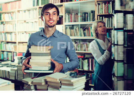 Smiling man having book pile in hands Smiling man having book pile in hands 26727120
