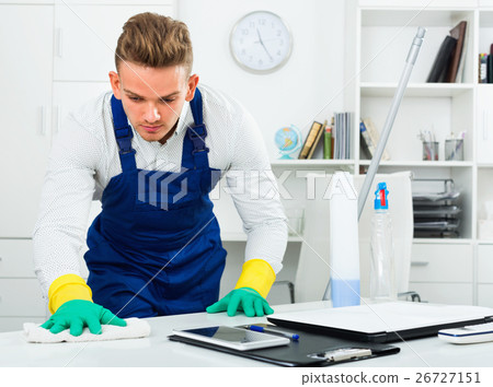 Male professional janitor dusting in office Male professional janitor dusting in office 26727151