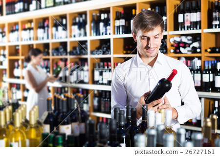 Man choosing bottle of wine 26727161