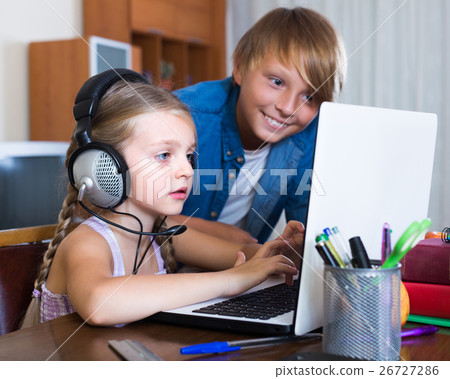 Children playing online on laptop. Children playing online on laptop. 26727286