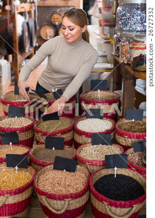 Cheerful female customer selecting dried bean 26727332