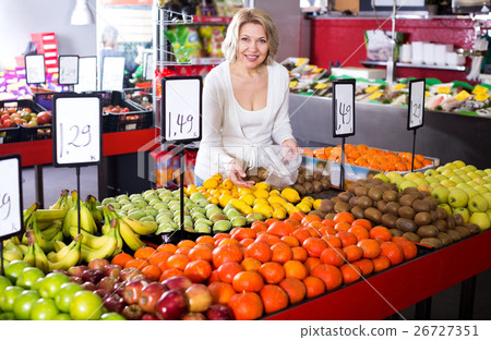 Female pensioner buying fresh fruits 26727351