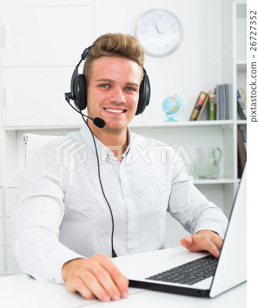 Young man working in call centre 26727352