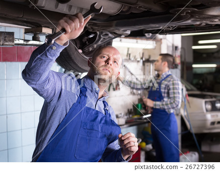 Two car mechanics at workshop Two car mechanics at workshop 26727396