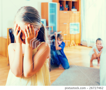 Teenage boy with sisters playing hide-and-go-seek 26727462