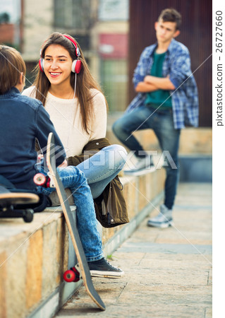 Upset boy and couple of teens apart on the street 26727660