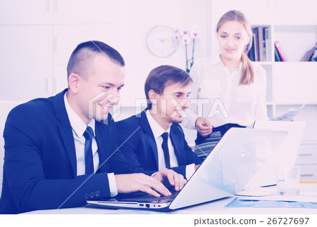 Coworkers working on document paper 26727697