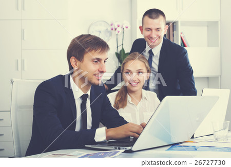 Business colleagues occupied with laptops Business colleagues occupied with laptops 26727730