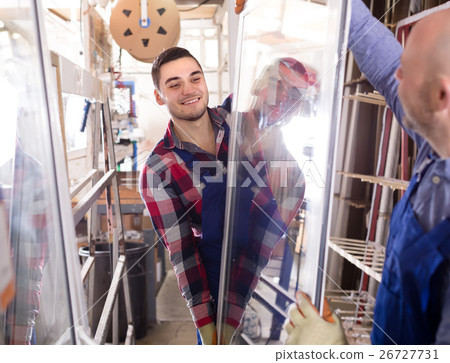 Two smiling workmen at factory 26727731
